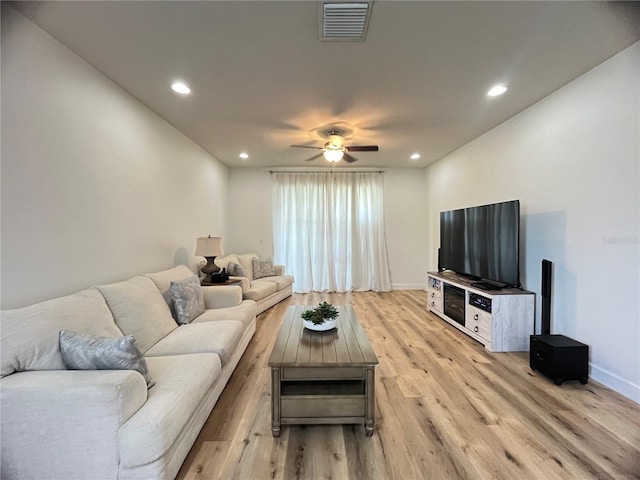 living room with a ceiling fan, light wood-type flooring, recessed lighting, and baseboards