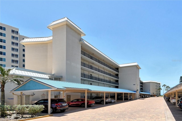 5916 Midnight Pass Rd Unit 404, Sarasota, FL 34242 - view of apartment building / complex featuring covered parking