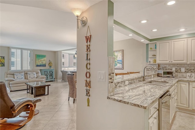 5916 Midnight Pass Rd Unit 404, Sarasota, FL 34242 - kitchen with light stone countertops, light tile patterned floors, tasteful backsplash, open floor plan, and stainless steel dishwasher