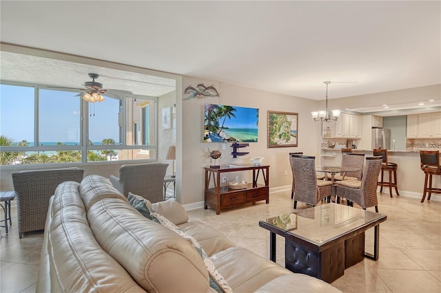 5916 Midnight Pass Rd Unit 404, Sarasota, FL 34242 - living room featuring a chandelier, a ceiling fan, light tile patterned floors, and baseboards