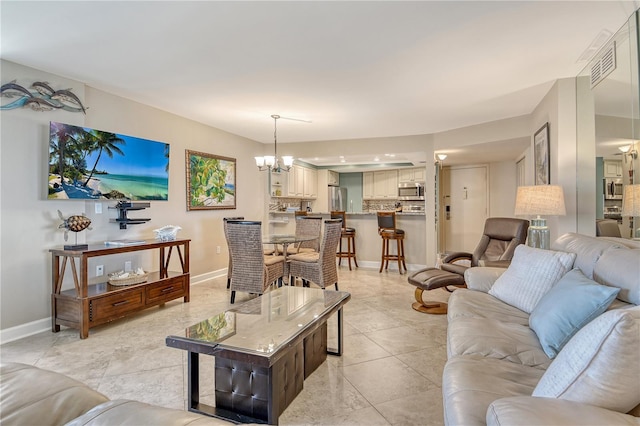5916 Midnight Pass Rd Unit 404, Sarasota, FL 34242 - living area featuring a chandelier, baseboards, and light tile patterned floors