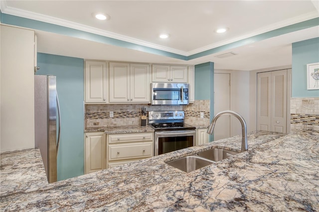 5916 Midnight Pass Rd Unit 404, Sarasota, FL 34242 - kitchen featuring stainless steel appliances, a sink, crown molding, light stone counters, and decorative backsplash