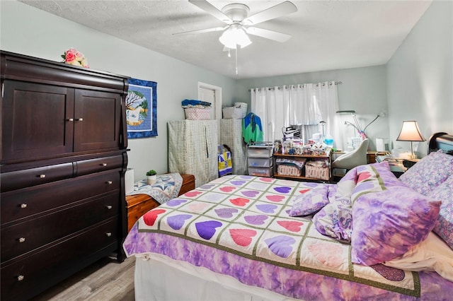 bedroom with light wood finished floors and ceiling fan