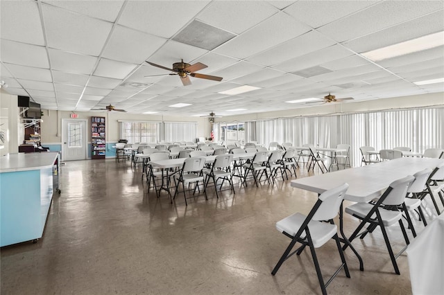 dining area with ceiling fan and a paneled ceiling
