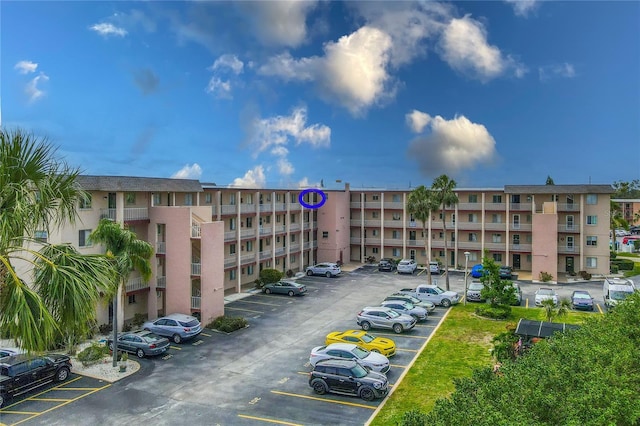 view of apartment building / complex featuring uncovered parking