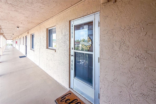 entrance to property with stucco siding