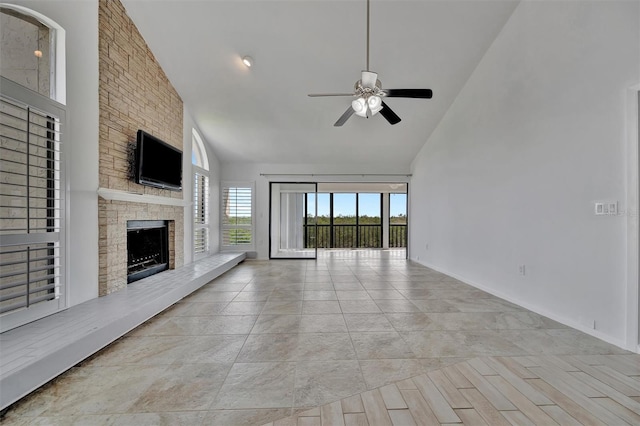 8710 54th Ave W Unit 8710, Bradenton, FL 34210 - unfurnished living room with a ceiling fan, high vaulted ceiling, a stone fireplace, and baseboards