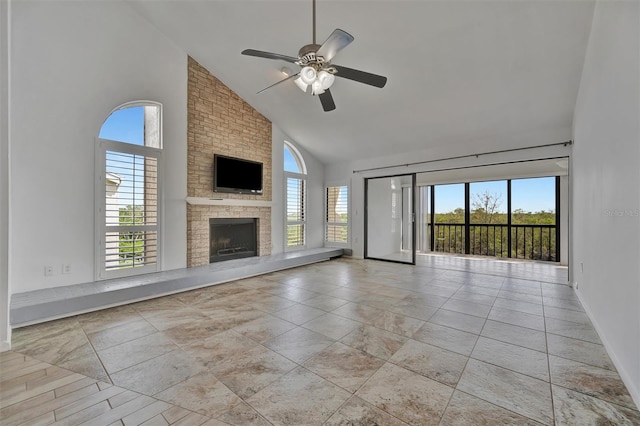 8710 54th Ave W Unit 8710, Bradenton, FL 34210 - unfurnished living room featuring high vaulted ceiling, a ceiling fan, a fireplace, and baseboards