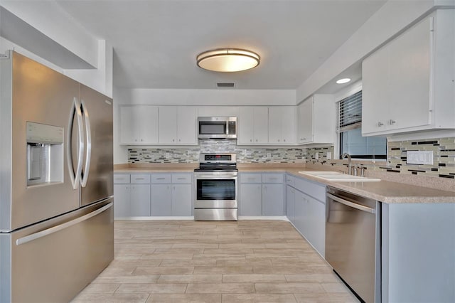 8710 54th Ave W Unit 8710, Bradenton, FL 34210 - kitchen with appliances with stainless steel finishes, a sink, light countertops, and tasteful backsplash