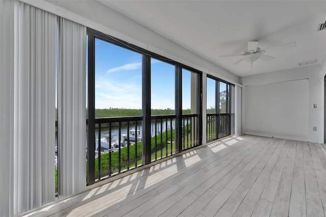 8710 54th Ave W Unit 8710, Bradenton, FL 34210 - unfurnished sunroom featuring wood finished floors and a water view