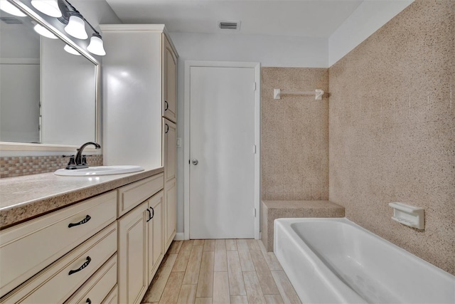 8710 54th Ave W Unit 8710, Bradenton, FL 34210 - bathroom featuring vanity, a tub to relax in, and wood finished floors