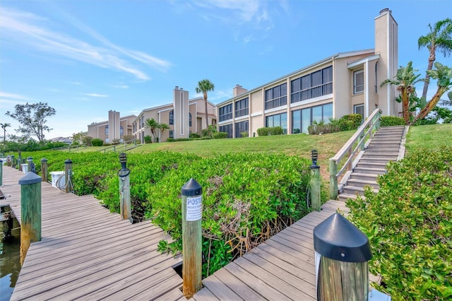 8710 54th Ave W Unit 8710, Bradenton, FL 34210 - dock area featuring stairway and a yard