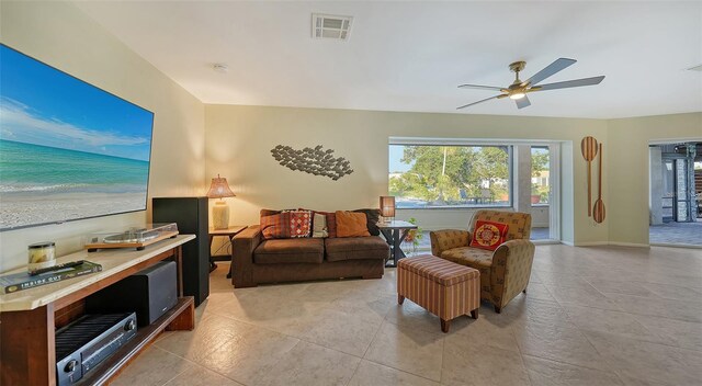 5500 Merrimac Dr, Sarasota, FL 34231 - living area with ceiling fan, light tile patterned flooring, and baseboards