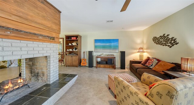 5500 Merrimac Dr, Sarasota, FL 34231 - living room with ceiling fan, a fireplace, and light tile patterned floors