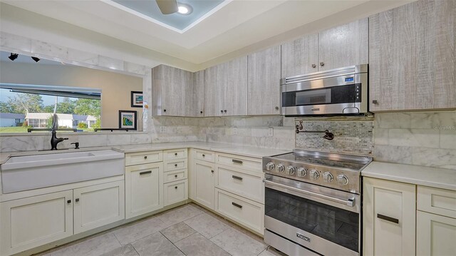 5500 Merrimac Dr, Sarasota, FL 34231 - kitchen featuring stainless steel appliances, a sink, light countertops, and backsplash