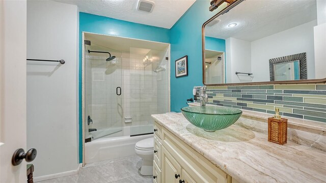 5500 Merrimac Dr, Sarasota, FL 34231 - full bath with vanity, enclosed tub / shower combo, toilet, decorative backsplash, and baseboards