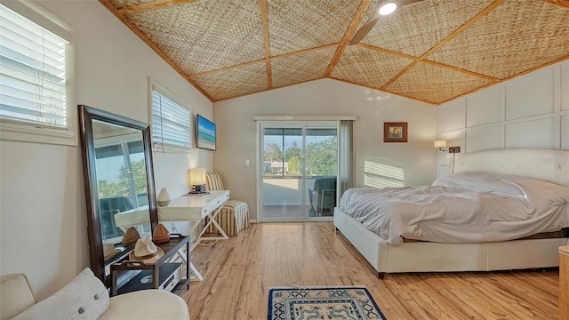 5500 Merrimac Dr, Sarasota, FL 34231 - bedroom featuring access to exterior, light wood-style floors, and vaulted ceiling