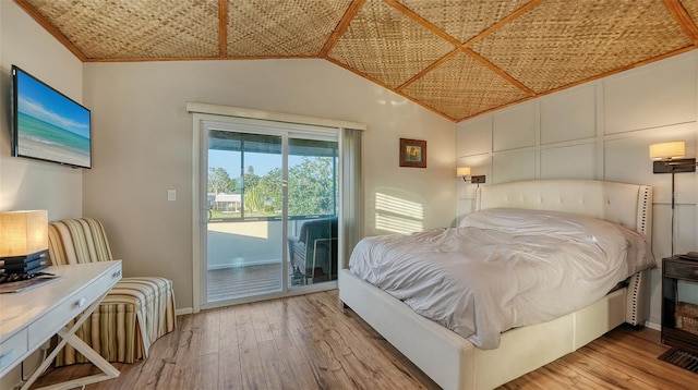 5500 Merrimac Dr, Sarasota, FL 34231 - bedroom featuring access to outside, hardwood / wood-style flooring, vaulted ceiling, baseboards, and ornamental molding