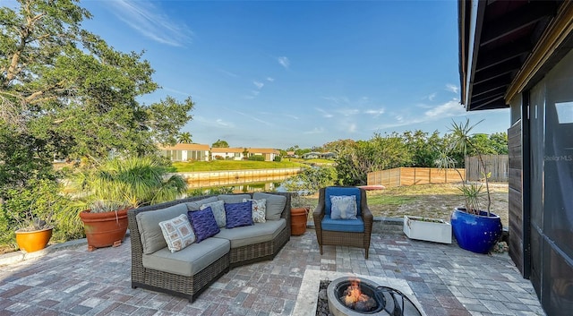 5500 Merrimac Dr, Sarasota, FL 34231 - view of patio featuring an outdoor living space with a fire pit and a fenced backyard