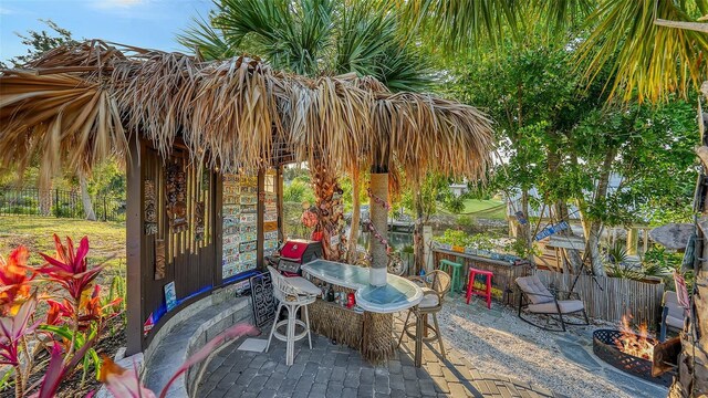 5500 Merrimac Dr, Sarasota, FL 34231 - view of patio / terrace with an outdoor fire pit and fence