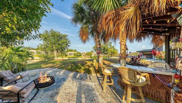 5500 Merrimac Dr, Sarasota, FL 34231 - view of patio featuring an outdoor fire pit