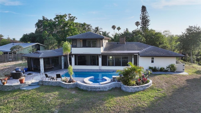 5500 Merrimac Dr, Sarasota, FL 34231 - rear view of property with a patio area, a sunroom, a chimney, a pool with connected hot tub, and stucco siding