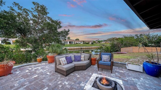 5500 Merrimac Dr, Sarasota, FL 34231 - patio terrace at dusk featuring an outdoor living space with a fire pit