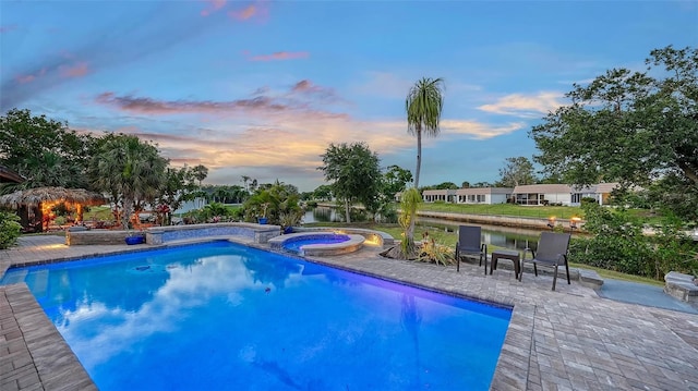 5500 Merrimac Dr, Sarasota, FL 34231 - view of pool with a patio area, a water view, and a pool with connected hot tub