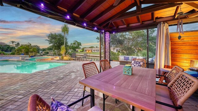 5500 Merrimac Dr, Sarasota, FL 34231 - view of patio featuring outdoor dining space and a pool with connected hot tub