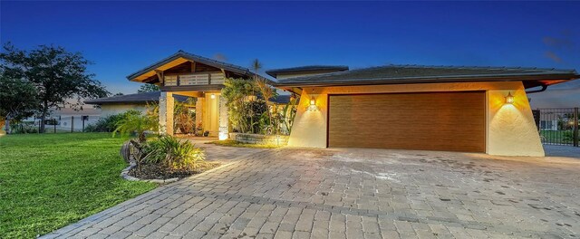5500 Merrimac Dr, Sarasota, FL 34231 - view of front of home with stucco siding, a garage, and decorative driveway