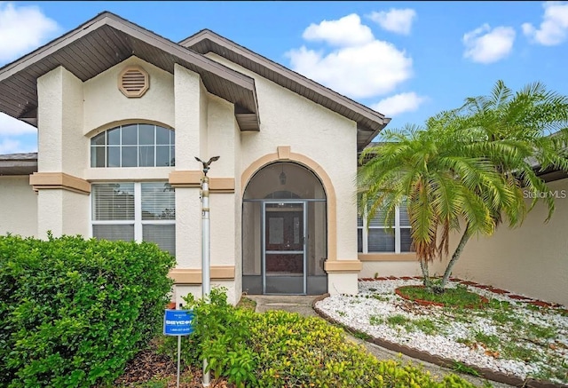 view of exterior entry with stucco siding