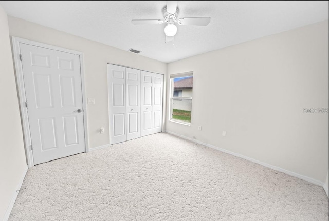 unfurnished bedroom featuring baseboards, carpet flooring, and a closet