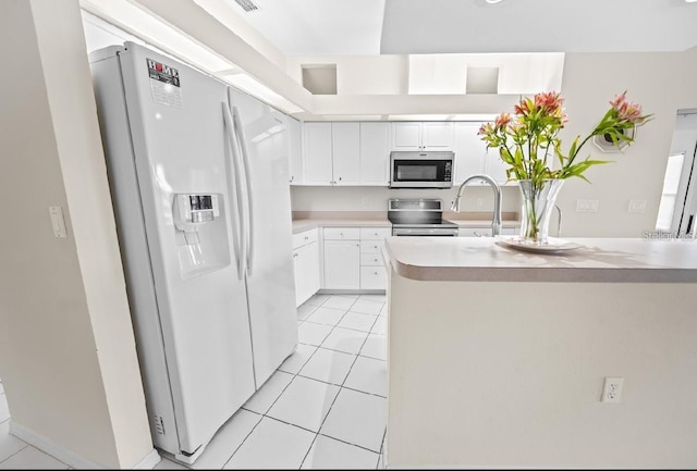 kitchen with stainless steel appliances, light tile patterned flooring, light countertops, white cabinetry, and a sink