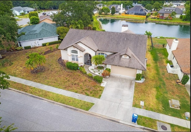 aerial view of residential area featuring a large body of water