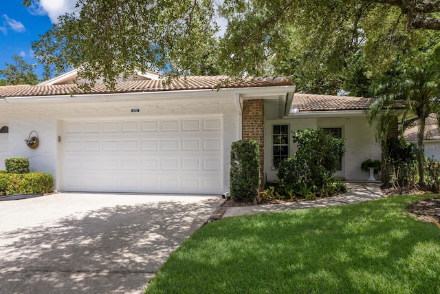 5712 Garden Lakes Dr, Bradenton, FL 34203 - view of front of property featuring a tiled roof, concrete driveway, an attached garage, and stucco siding