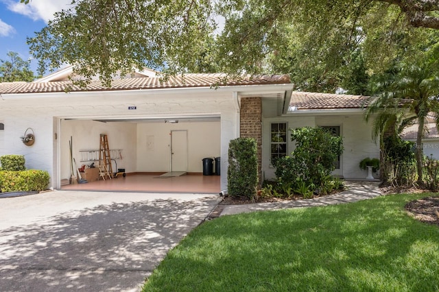 5712 Garden Lakes Dr, Bradenton, FL 34203 - view of front facade featuring a tiled roof, concrete driveway, an attached garage, and a front lawn
