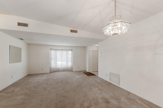 5712 Garden Lakes Dr, Bradenton, FL 34203 - spare room with light carpet and a chandelier