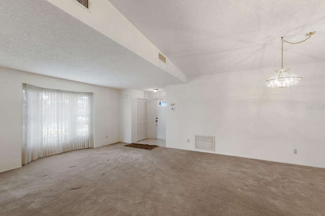 5712 Garden Lakes Dr, Bradenton, FL 34203 - unfurnished room with carpet flooring, a chandelier, and a textured ceiling