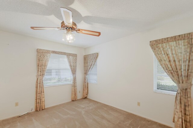 5712 Garden Lakes Dr, Bradenton, FL 34203 - empty room with plenty of natural light, carpet floors, and a ceiling fan
