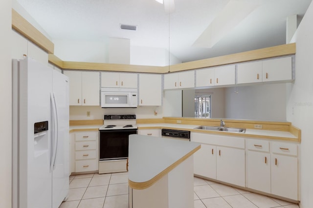 5712 Garden Lakes Dr, Bradenton, FL 34203 - kitchen with white appliances, a sink, light tile patterned floors, light countertops, and vaulted ceiling
