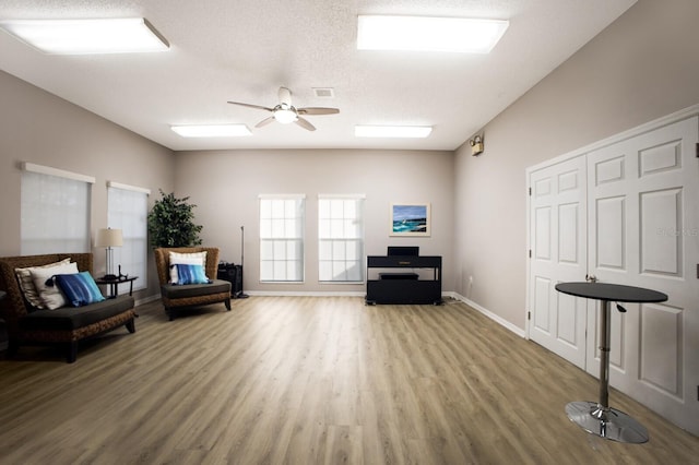 5712 Garden Lakes Dr, Bradenton, FL 34203 - sitting room with wood finished floors, a ceiling fan, and baseboards