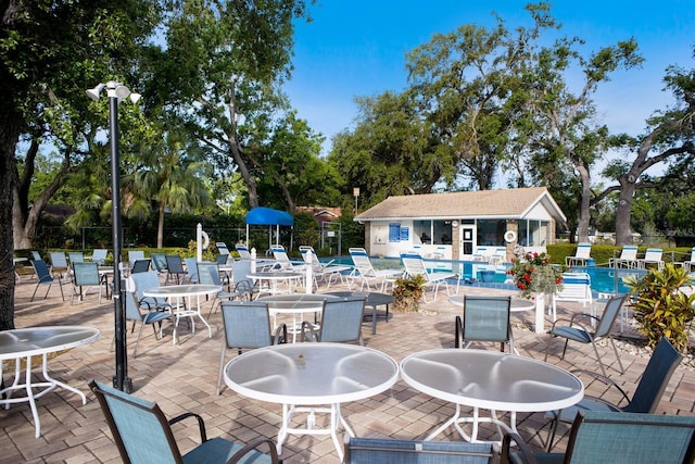 5712 Garden Lakes Dr, Bradenton, FL 34203 - view of patio featuring a community pool and fence