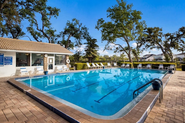 5712 Garden Lakes Dr, Bradenton, FL 34203 - community pool featuring fence, a patio area, and an outbuilding