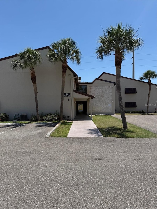 7273 Cloister Dr Unit 121, Sarasota, FL 34231 - view of property featuring central AC unit and uncovered parking