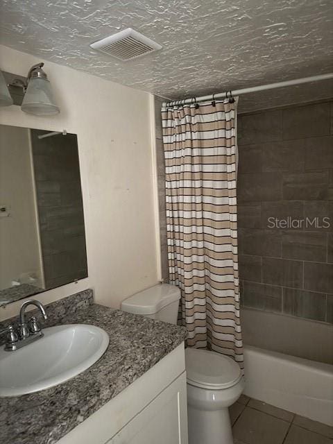 7273 Cloister Dr Unit 121, Sarasota, FL 34231 - full bathroom featuring vanity, tile patterned floors, toilet, and shower / bath combo with shower curtain