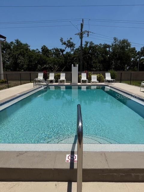 7273 Cloister Dr Unit 121, Sarasota, FL 34231 - community pool with a patio area