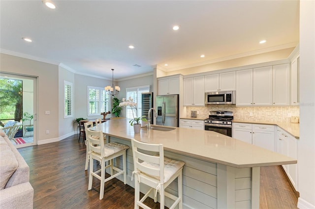 5035 Tobermory Way, Bradenton, FL 34211 - kitchen featuring appliances with stainless steel finishes, a sink, a chandelier, backsplash, and dark wood-style floors
