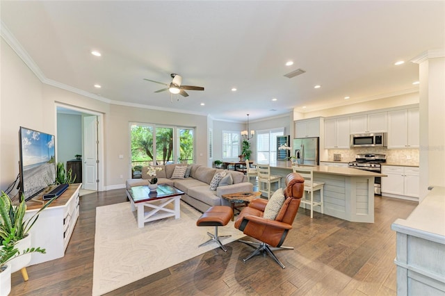 5035 Tobermory Way, Bradenton, FL 34211 - living area with crown molding, a ceiling fan, dark wood-style flooring, and recessed lighting
