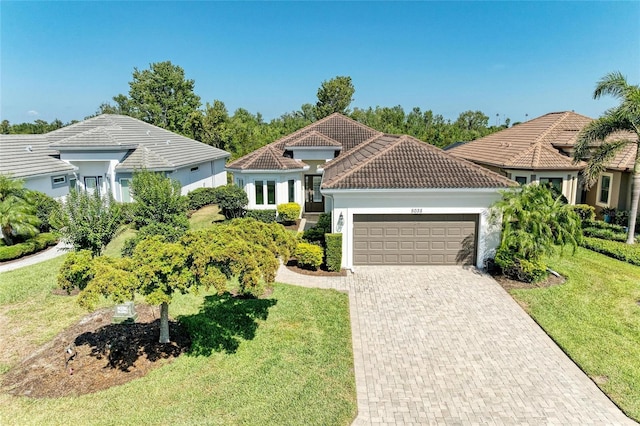 5035 Tobermory Way, Bradenton, FL 34211 - view of front of home with an attached garage, a front lawn, decorative driveway, and a tile roof