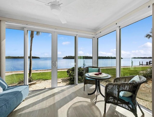 4310 Falmouth Dr Unit 105, Longboat Key, FL 34228 - sunroom with a water view, ceiling fan, and wood finished floors